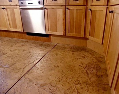 brown cabinets on stamped concrete kitchen floor.
