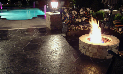 dark grey slate stamped concrete patio with fire pit.