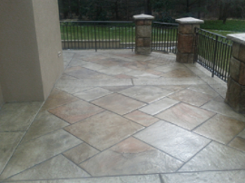 stamped concrete patio with fencing around patio.